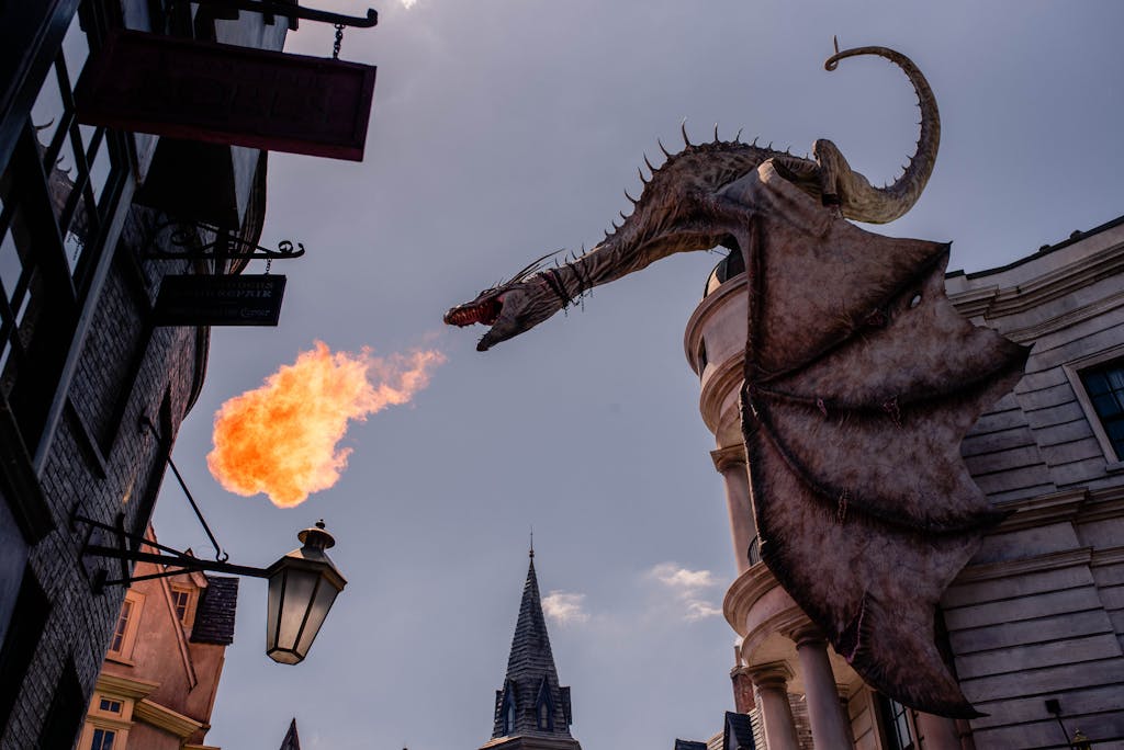 Stunning dragon sculpture breathing fire at a themed street in Orlando, Florida.